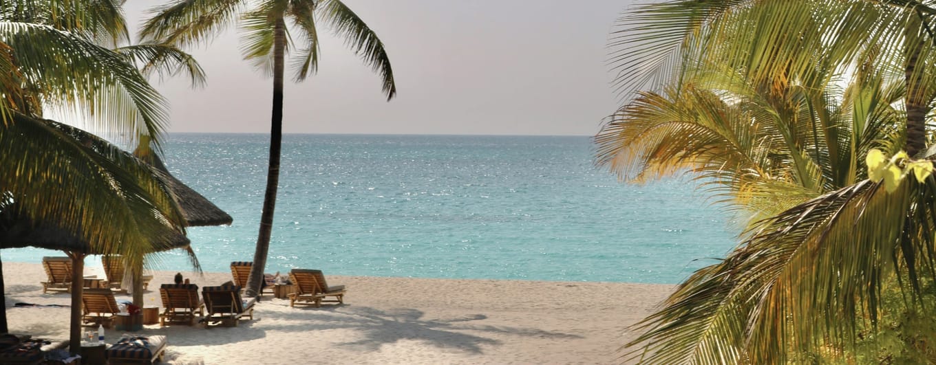 White sand beach and blue waters of Zanzibar in Tanzania