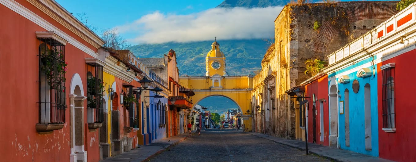 Colourful town in Central America with volcano in the background