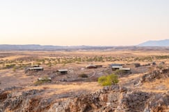 Aerial view of Namibian desert with tented camp