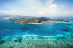 como laucala island aerial island view with blue waters