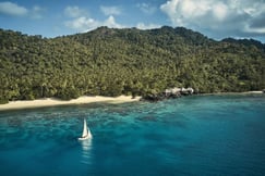 sailing boat with white sand beach and luxury villa in fiji