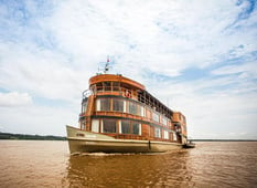 exterior of small luxury cruise ship on amazon river