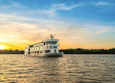 exterior of small luxury delfin cruise ship on amazon river at sunset