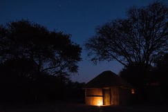 Chalet exterior by the night at Ntemwa-Busanga Camp