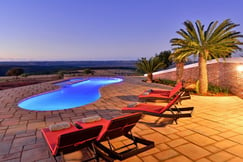 Swimming pool with views of the African bush at dusk