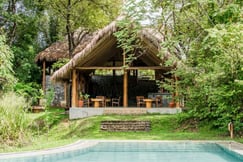 Outside seating are and restaurant at Gal Oya Lodge