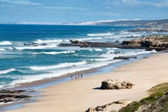 People walking along private beach at Lekkerwater