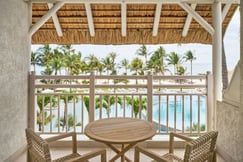 Hotel balcony with view over the pool and sea