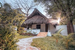 Garden room surrounded by trees at The Manta Resort on Pemba Island