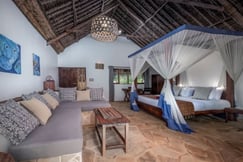 Suite with a four poster bed at The Manta Resort