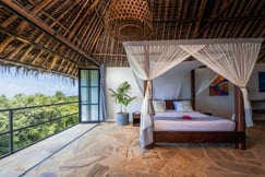 Four poster bed with views over the surrounding jungle at the Manta Resort