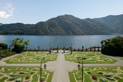 Manicured Italian gardens at Villa Sola Cabiati overlooking Lake Como and the Alps in the distance