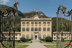 The exterior of Villa Sola Cabiati with mountains behind