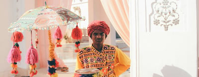 View of man in turban with ornate umbrella