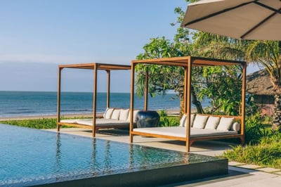 Sunloungers next to the pool by the beach