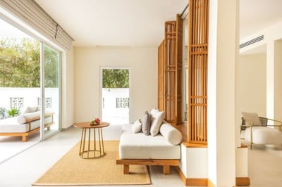 Hotel suite living room with sofa, table and chairs