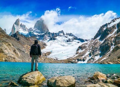 man looking at lake and mountains in Patagonia