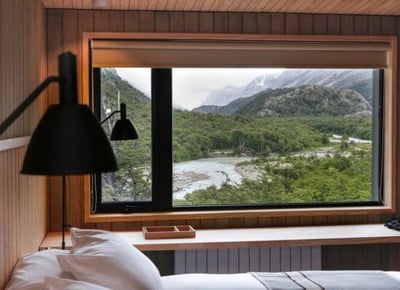 view out of a bedroom to mountains in patagonia