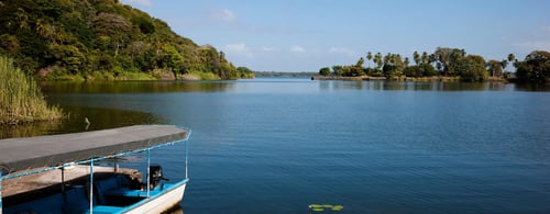 View of a lake with small island and boat in Central America