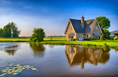 Red bricks house in countryside near the lake with mirror reflection in water, Amsterdam, Holland, Netherlands, HDR