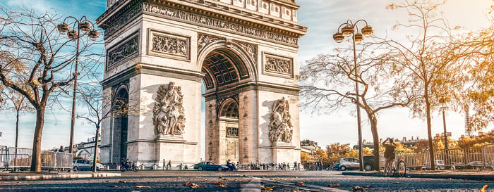 Arc de Triomphe located in Paris, in autumn scenery.