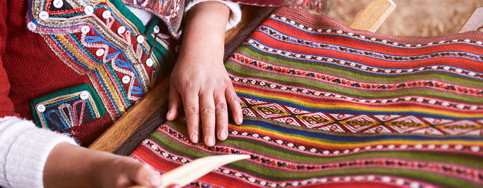 Traditional handmade wool production in Cusco Peru. Colorful alpaca clothing